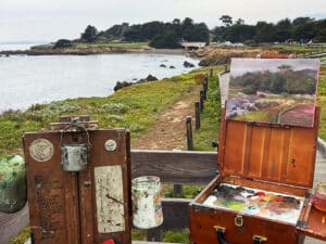 Plein air painting setup overlooking the Cambria coastline and boardwalk in California.