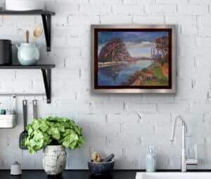 Framed Morro Rock plein air painting displayed in a contemporary interior setting.