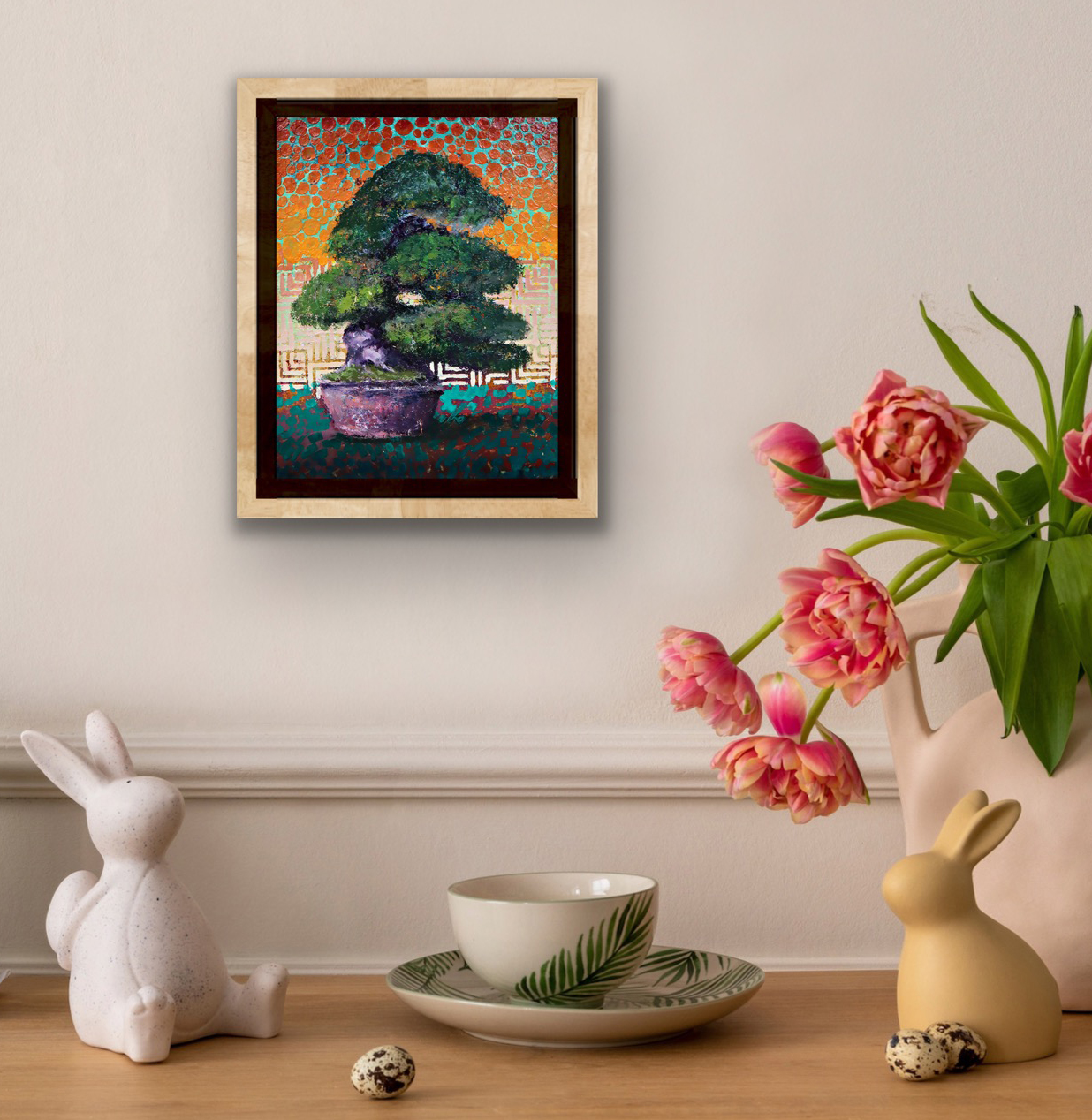 Crinkled Crepe mixed-media bonsai painting by Ron Reekers, featuring a 60-year-old Chirimen Vine with a lush green canopy against a vibrant orange and turquoise patterned background, displayed in a natural wood frame above a decorative tabletop with pink tulips and ceramic objects.