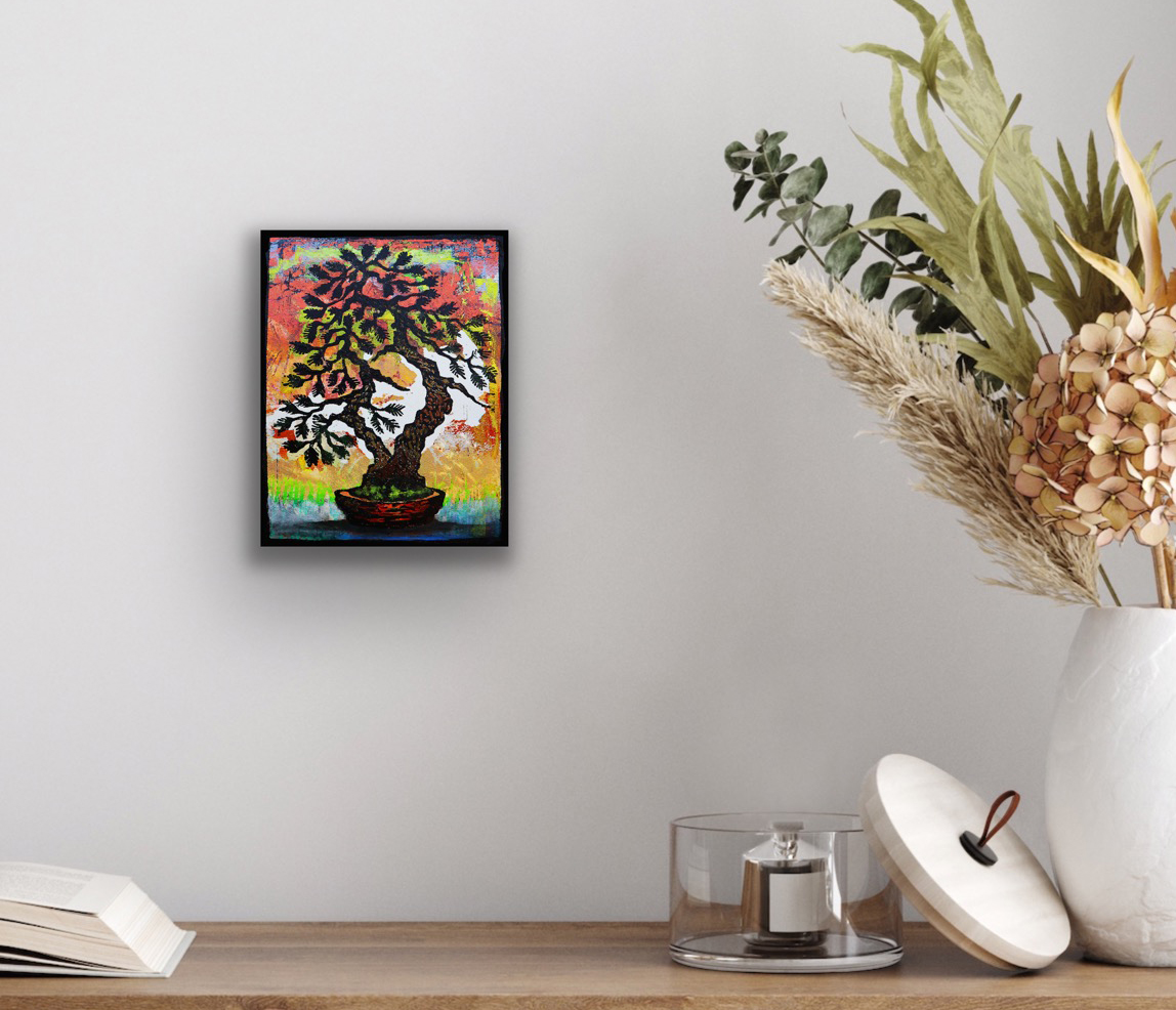 Cypress Twin Monoprint #1 by Ron Reekers displayed in a black frame above a wooden console, showing how colorful Japanese-inspired bonsai artwork complements a contemporary interior.
