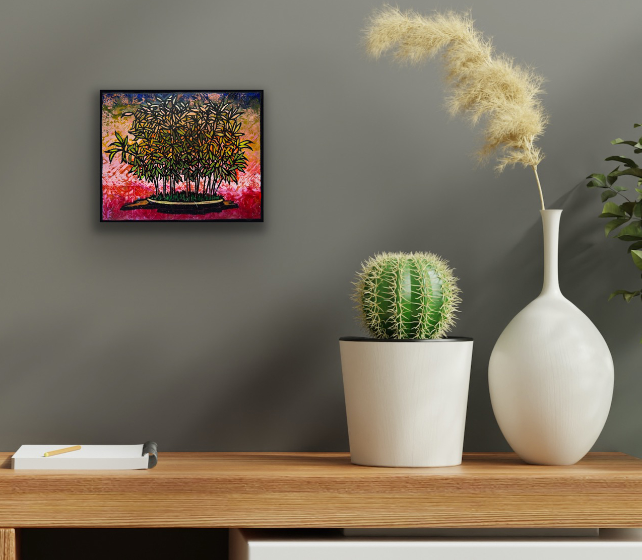 Hime Moso Bamboo Monoprint #2 displayed on a gray wall above a wooden console with a cactus and decorative white vase, illustrating the artwork in a contemporary interior.
