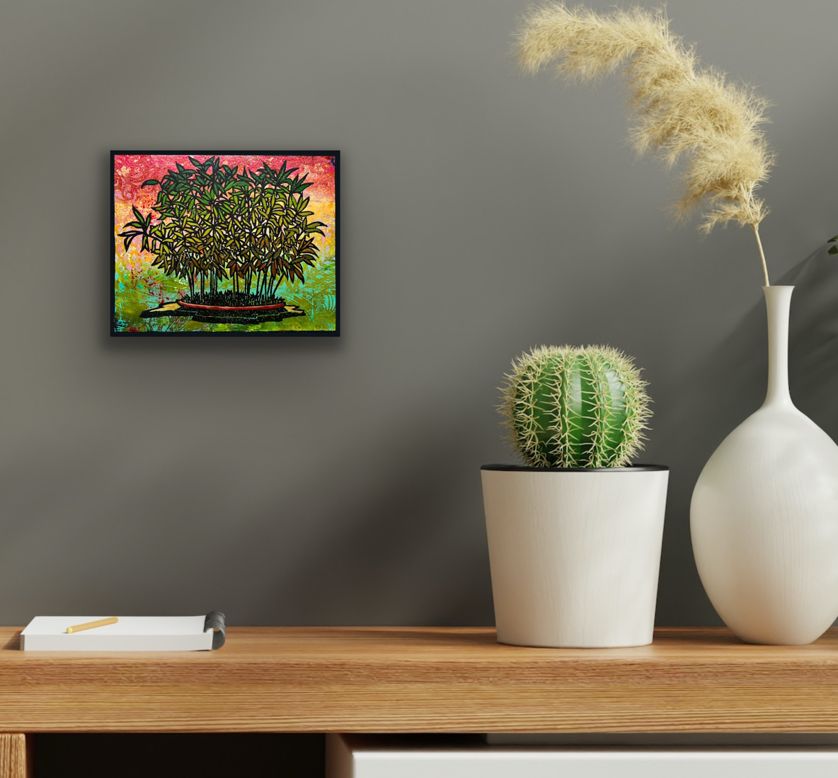 Hime Moso Bamboo Monoprint #3 by Ron Reekers displayed in a black frame on a gray wall above a wooden console, alongside a potted cactus and sculptural white vase in a contemporary interior.